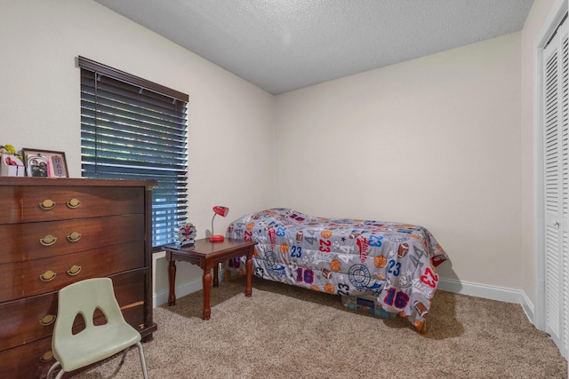 628 Annarose Dr, Dallas, TX 75232 - carpeted bedroom with baseboards, a textured ceiling, and a closet
