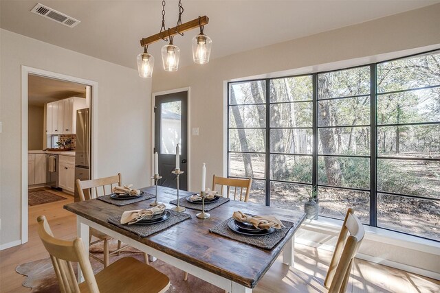 dining space featuring plenty of natural light and light wood-type flooring