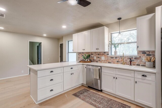 kitchen featuring kitchen peninsula, sink, white cabinetry, and dishwasher