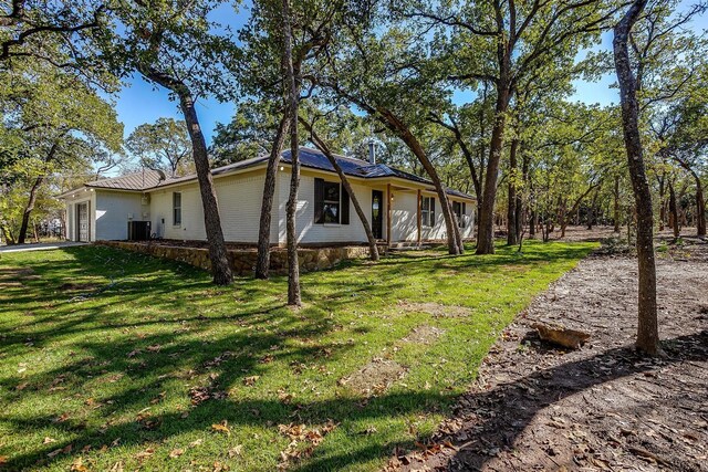 view of front of property featuring cooling unit and a front yard