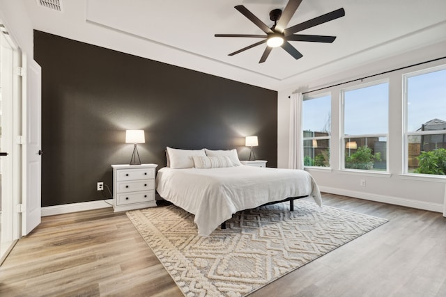 bedroom with ceiling fan and light hardwood / wood-style floors