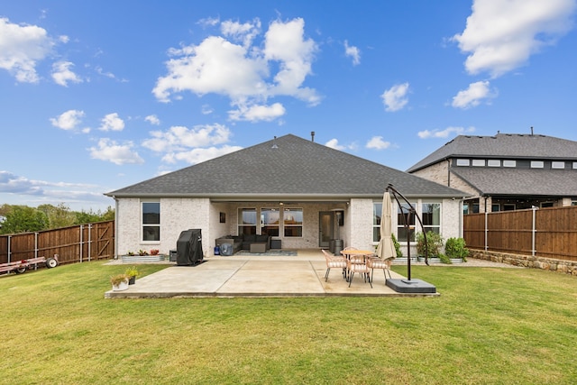 back of property with a lawn and a patio area