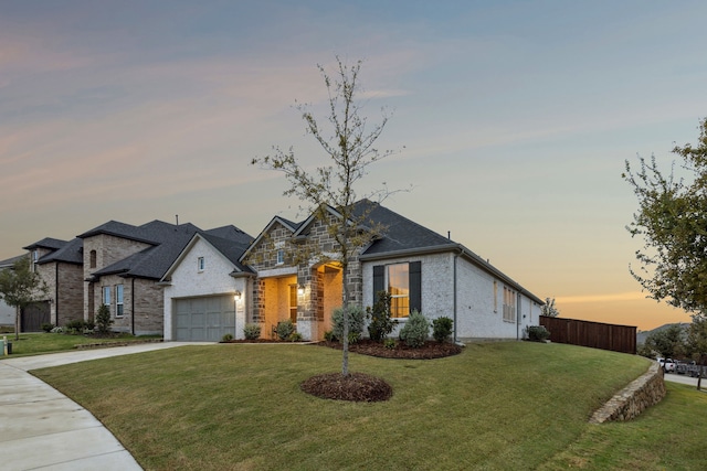 view of front of home with a garage and a yard