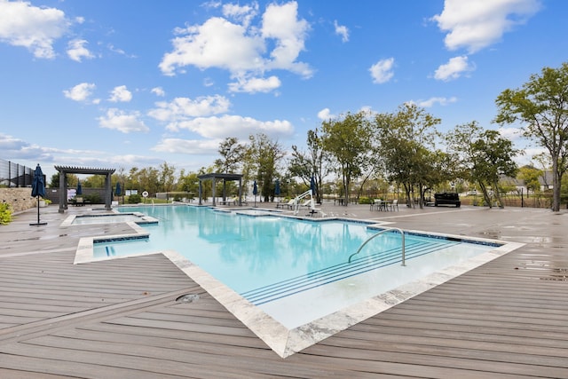 view of swimming pool featuring a hot tub and a patio area