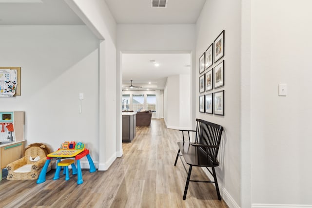 corridor with light hardwood / wood-style floors