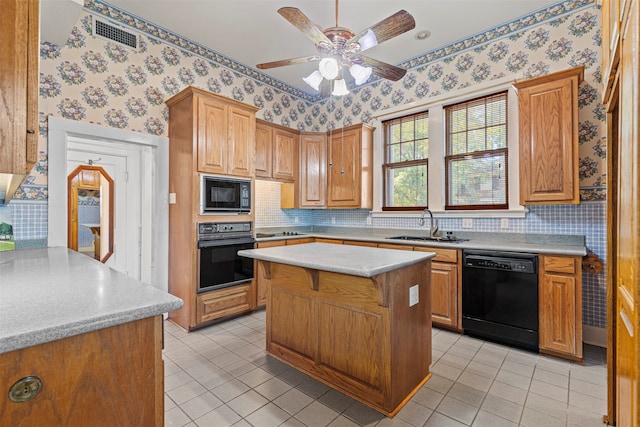 kitchen featuring light tile patterned flooring, sink, black appliances, ceiling fan, and a center island