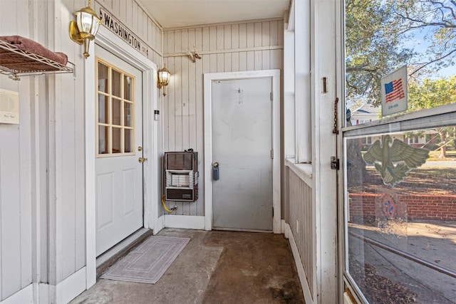 doorway to outside featuring wood walls