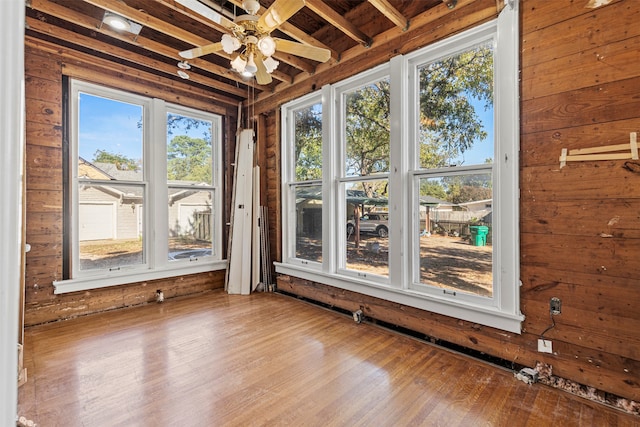 unfurnished sunroom with ceiling fan and plenty of natural light