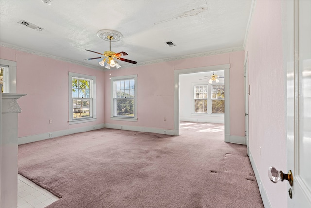 unfurnished living room with ornamental molding, a textured ceiling, light colored carpet, and ceiling fan