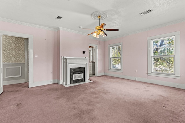 unfurnished living room with a textured ceiling, light colored carpet, ceiling fan, and crown molding