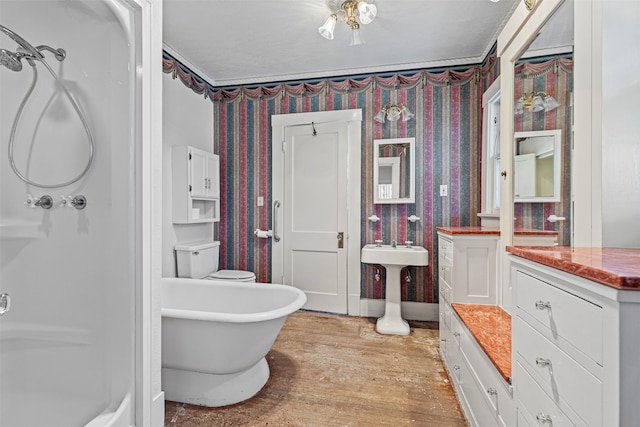 bathroom with a bathtub, wood-type flooring, and toilet