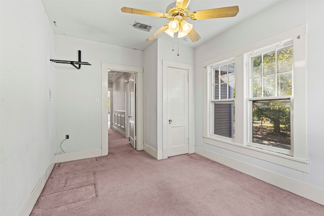 carpeted spare room with ceiling fan