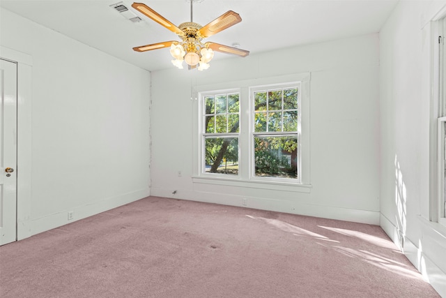 spare room with ceiling fan and light colored carpet