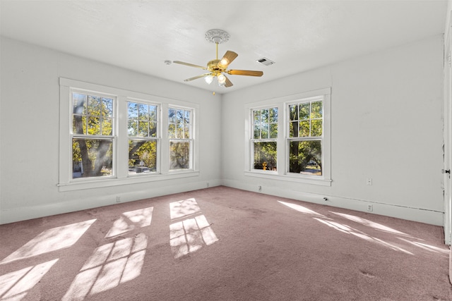 empty room featuring ceiling fan and carpet floors