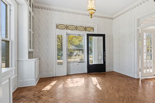 entryway featuring parquet floors, plenty of natural light, and ornamental molding