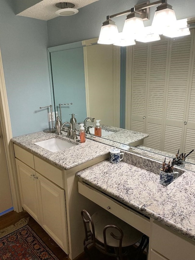 bathroom with vanity and a textured ceiling