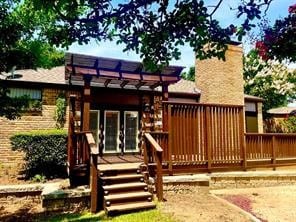 rear view of property with a wooden deck