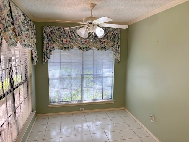 unfurnished dining area featuring a textured ceiling, ceiling fan, crown molding, and light tile patterned floors