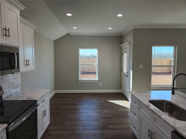 kitchen featuring sink, range with electric cooktop, dark hardwood / wood-style floors, light stone countertops, and white cabinets