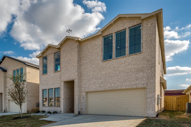 view of front of house featuring central air condition unit and a garage