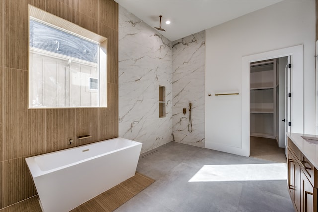 bathroom featuring a bathtub and tile walls