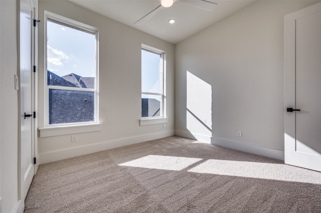 carpeted spare room with ceiling fan