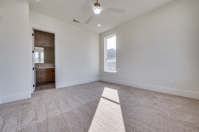 unfurnished room featuring ceiling fan and light colored carpet