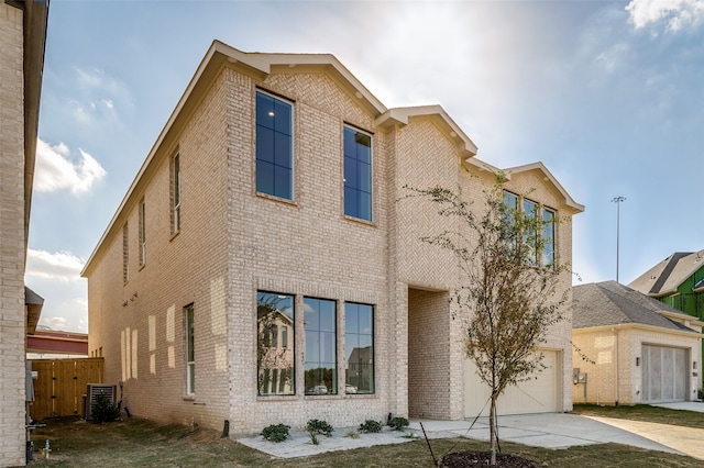 view of front of home featuring a garage and cooling unit