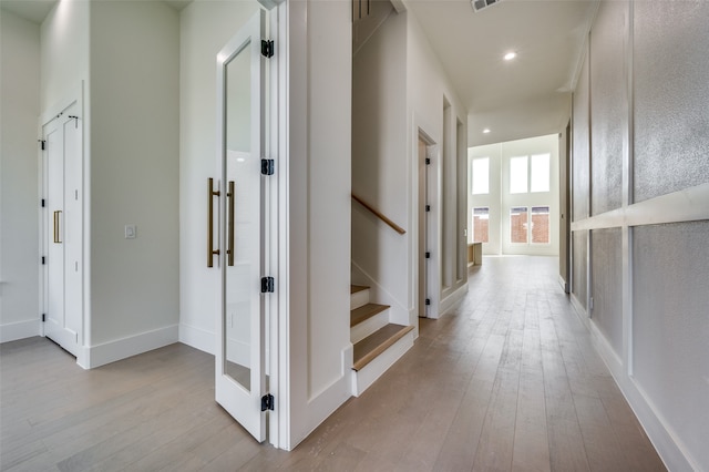 hallway with light hardwood / wood-style flooring