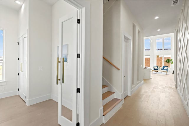 hall with light hardwood / wood-style floors