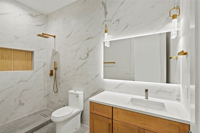 bathroom with tile walls, vanity, toilet, and a tile shower