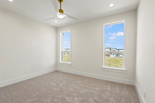 empty room with carpet flooring and ceiling fan