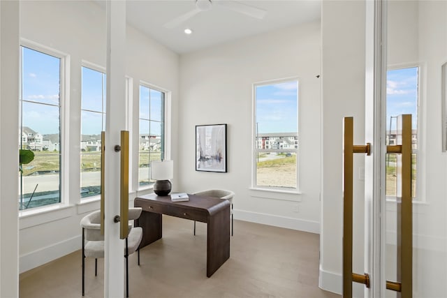 office space featuring light hardwood / wood-style floors and ceiling fan