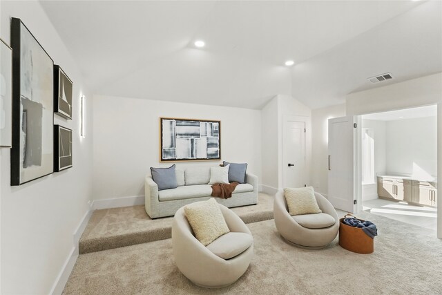 carpeted living room featuring vaulted ceiling