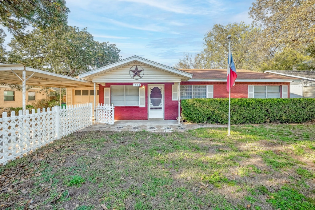 ranch-style home with a carport and covered porch