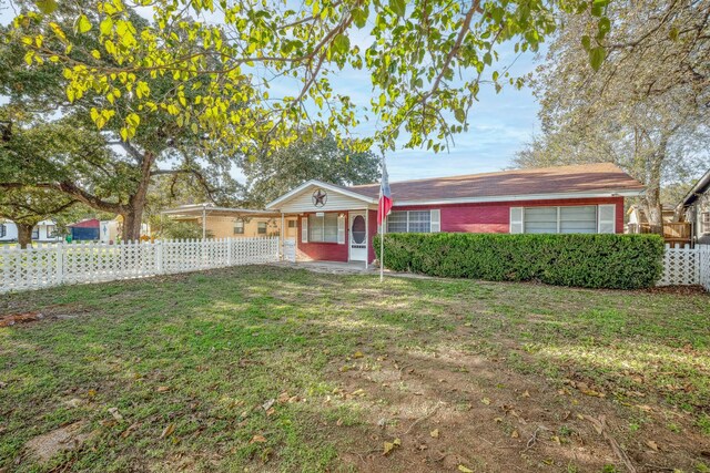 single story home featuring covered porch and a front yard