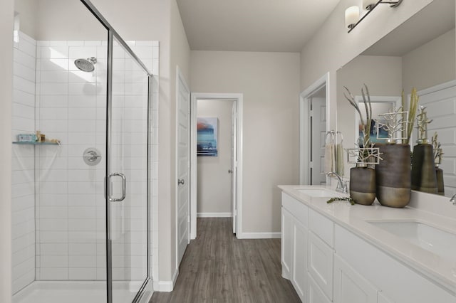 bathroom featuring an enclosed shower, vanity, and hardwood / wood-style flooring