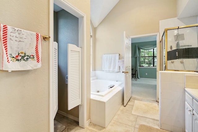 bathroom featuring vanity, plus walk in shower, lofted ceiling, and tile patterned flooring