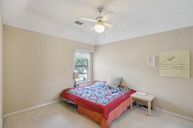 bedroom with ceiling fan, a textured ceiling, and carpet floors