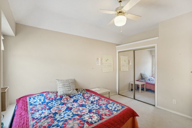 carpeted bedroom featuring ceiling fan, a closet, and lofted ceiling