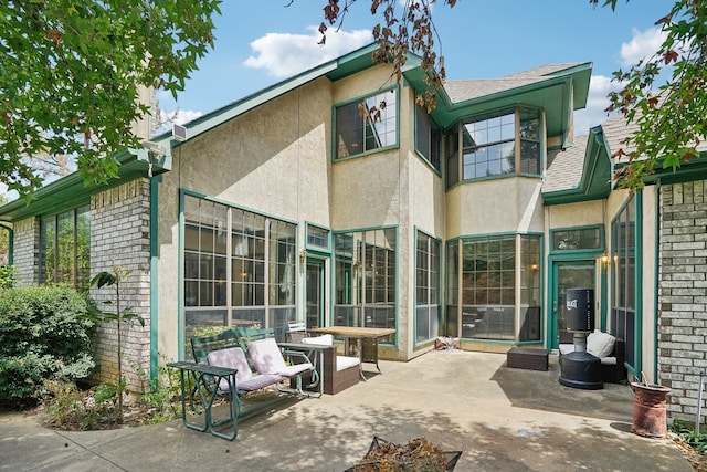 rear view of house featuring a patio