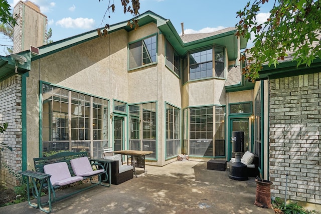 back of property with a patio