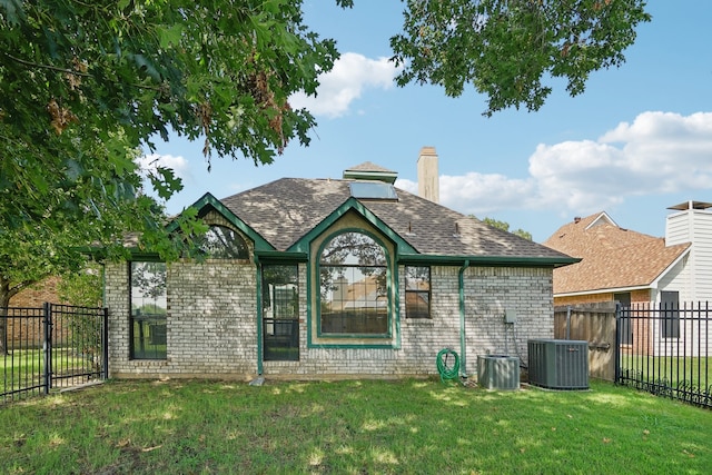 rear view of property with a yard and cooling unit