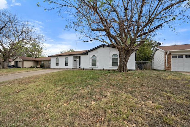 single story home with a garage and a front lawn