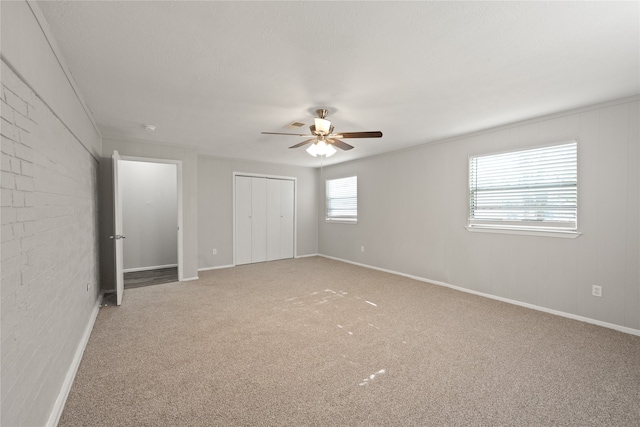 unfurnished bedroom featuring ceiling fan, a closet, and carpet floors