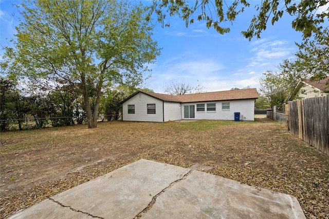 back of house with a patio