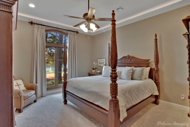 carpeted bedroom featuring ceiling fan, multiple windows, and ornamental molding