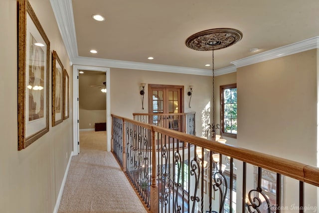 corridor with light colored carpet and ornamental molding