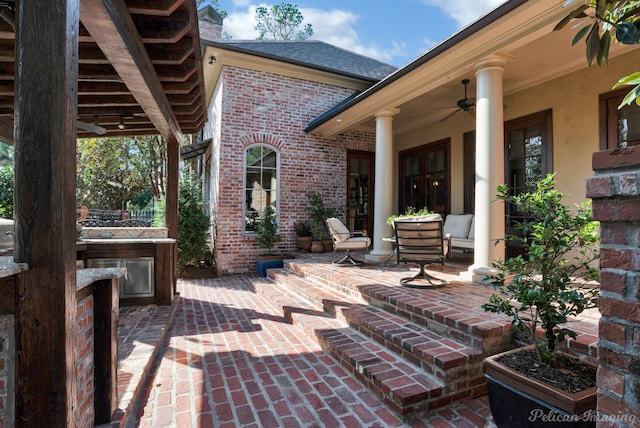 view of patio featuring an outdoor kitchen and ceiling fan