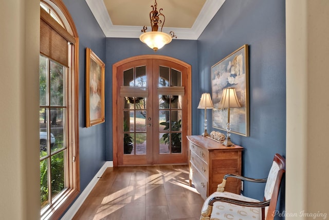 doorway to outside featuring french doors, plenty of natural light, dark tile patterned flooring, and crown molding